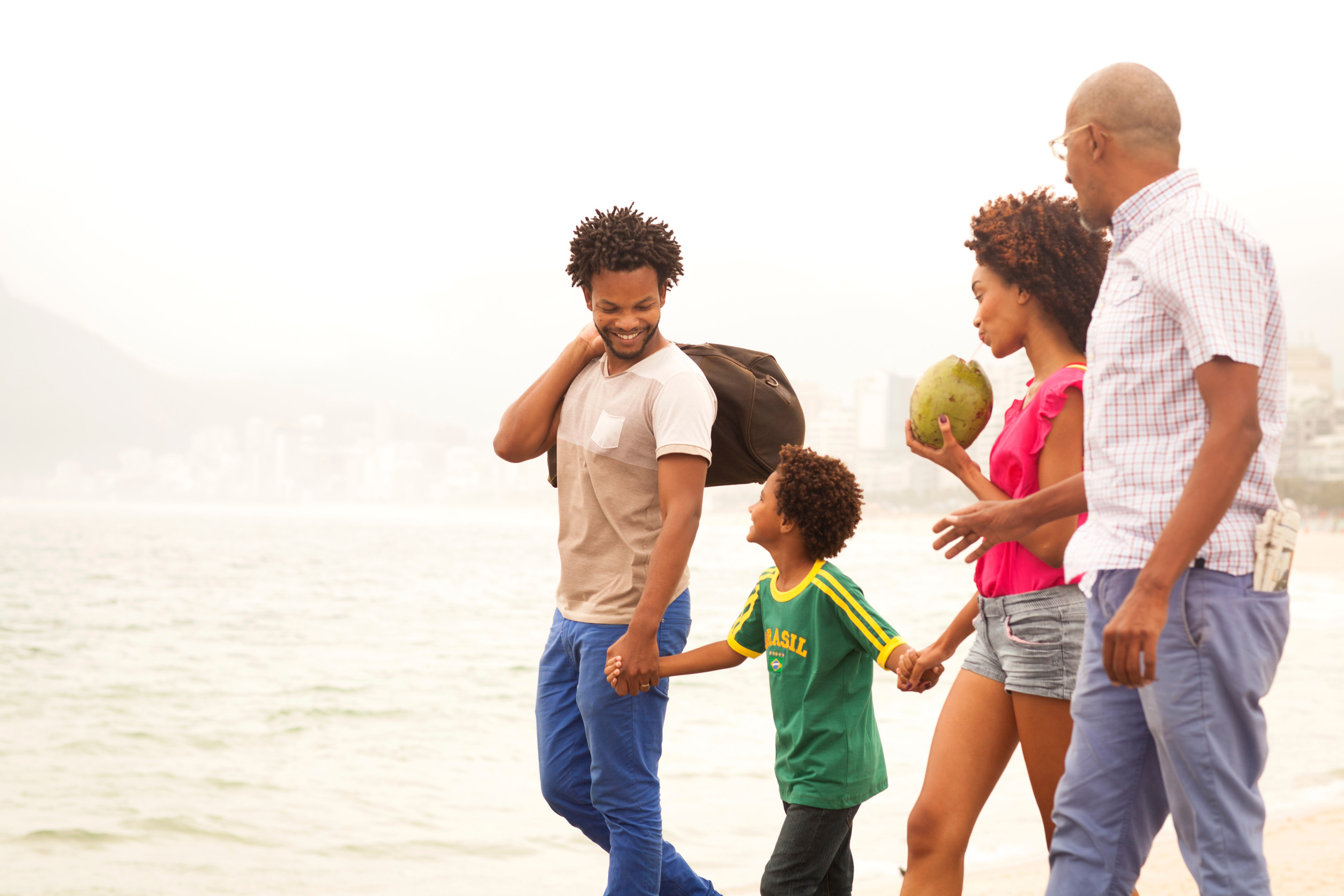 Family strolling along Ipanema Beach, Rio De Janeiro, Brazil